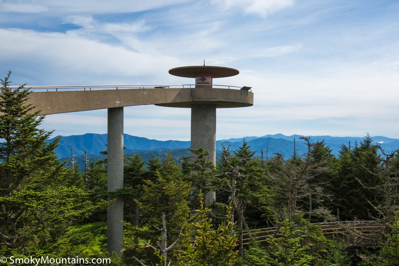 clingmans dome above green trees and cloudy blue skies