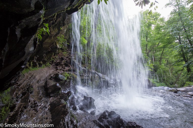 view from behind a waterfall on a hike