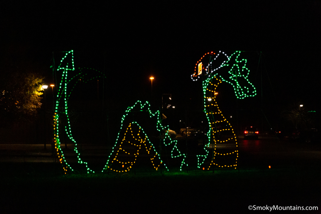 green dinosaur lit up at shadrack's christmas