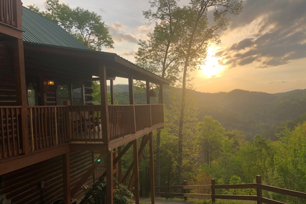 Sunset over mountains with cabin in Sevierville, TN