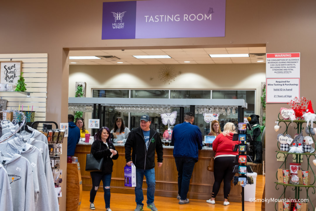 people waiting on bar area at the hilldside winery tasting room