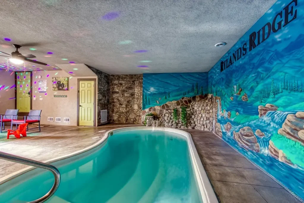 water-themed mural painted on pool wall with stones, indoor pool