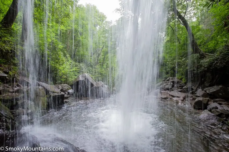 waterfalls cascading into a pool with rocks surrounding them