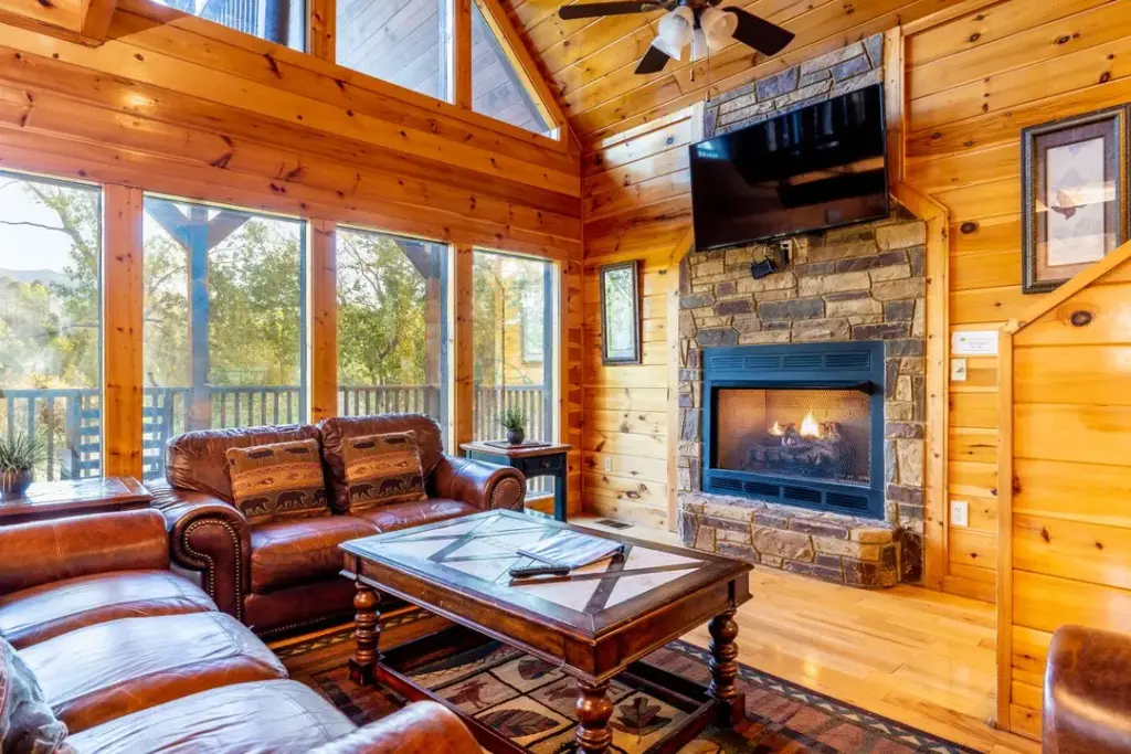 living room with fireplace and brown leather couches