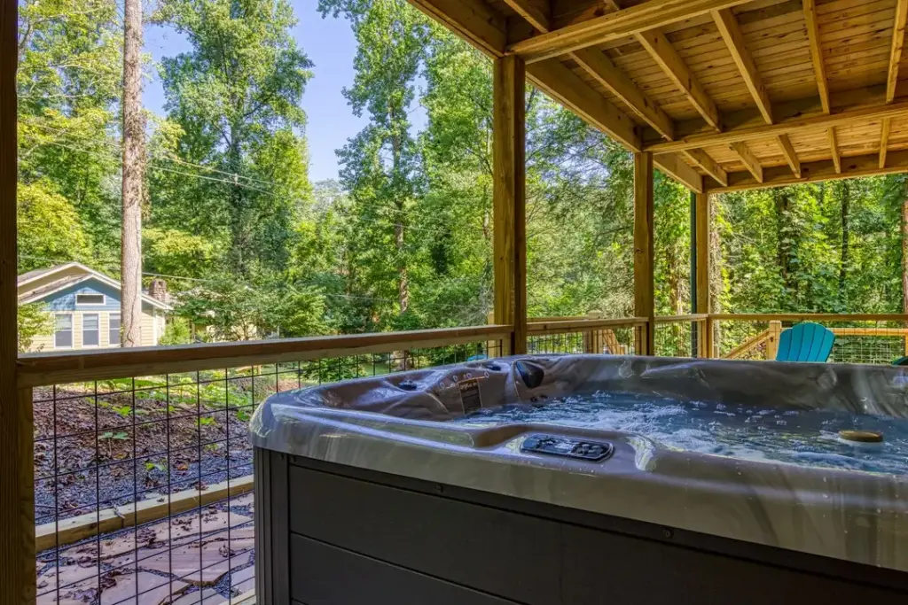 private hot tub on balcony next to green chair