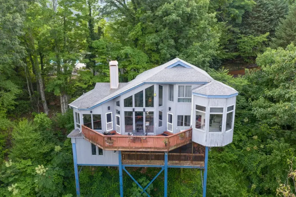 birds eye view of light blue and grey home and red balcony