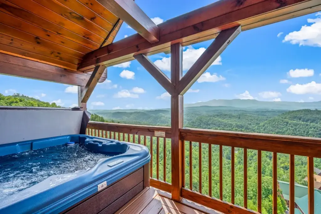 private hot tub on a cabin balcony overlooking mountains