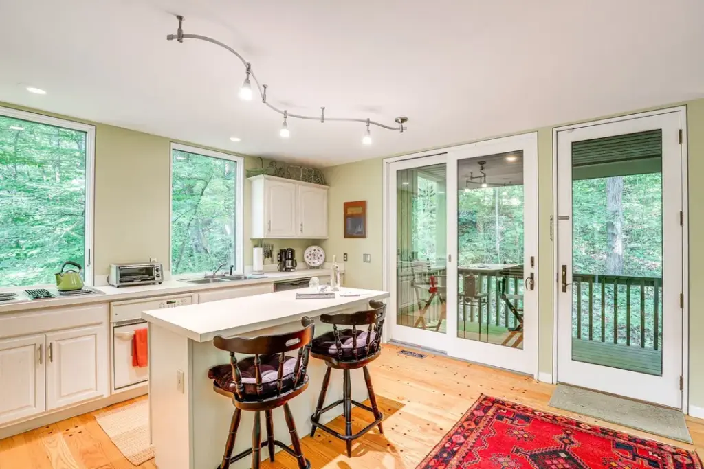 interior of asheville home with kitchen and barstools at island