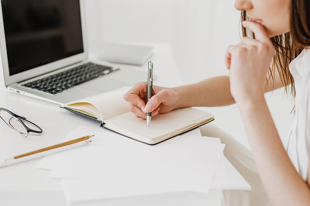 Woman writing in notebook